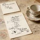 Two handwritten letters on a textured surface with a teacup and saucer.