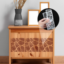 Wooden cabinet with decorative patterns, a vase, and a hand holding a white object.