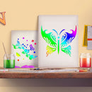 Two colorful butterfly art prints displayed on a wooden shelf, surrounded by paint jars, brushes, and a candle against a warm beige wall.