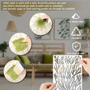 A reusable stenciled pattern sheet with a coral or branch-like cutout design is shown being held by hands in a living room setting, with three circular inset demonstration photos on the left and feature icons on the right reading 'no sharp edge,' 'reusable,' and 'non-toxic & safe.'.