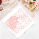 A square white art print featuring a pink architectural illustration surrounded by script, styled flat-lay on a white surface with a lace cloth, flowers, and a small pink petal.