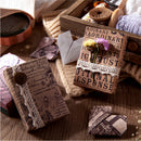 Decorative envelopes with vintage-style text and patterns on a wooden surface.