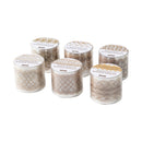 Set of six small cylindrical candles with decorative lids on a white background