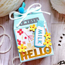 Decorative milk carton with flowers and text on a wooden surface