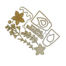 A gold metal die-cut craft embellishment featuring floral motifs, berries, and a script word reading 'Grimgrimm' on a plain white background.