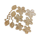 Gold metal craft dies featuring five-petal flowers and leaf designs, arranged on a plain white background.