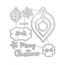 A set of Christmas-themed metal cutting dies arranged on a plain white background, including ornament, star, bow, and 'Merry Christmas' cutout shapes.