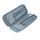 An open zippered travel or makeup organizer case with light blue fabric lining and gray interior compartments, shown on a plain white background.