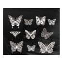 Nine silver butterfly-shaped nail art stickers with intricate lace-like patterns, arranged on a black background.