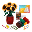 Crochet sunflower kit with a completed sunflower arrangement in a red crocheted pot, plus yarn balls in green, brown, red, yellow, and gray, crochet hooks, scissors, floral wire, and a beginner crochet set pouch on a white background.