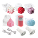 A candle-making kit with multiple wicks, wax melts, and molds, including a pink teardrop-shaped mold, a red rose-shaped mold, a purple grape-shaped mold, a pink candle, a red candle, a blue scallop-shaped mold, and white metal wick trims.