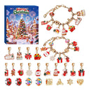 Christmas-themed charm beads and matching jewelry charms displayed alongside a festive gift box. The set includes gold-tone chain bracelets and individual bead charms with holiday motifs such as Santa Claus, snowflakes, gingerbread men, stockings, gifts, and a Christmas tree, shown on a plain white background.