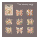 A sheet of butterfly-themed decorative stickers or decals on a muted taupe background. The design includes a larger butterfly illustration labeled 'Butterflies by Butterflies' and nine smaller butterfly motifs in soft peach, pink, cream, and muted green tones with lace-like outlines.