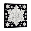 A square black canvas wall art print featuring a large ornate snowflake design in white and silver tones, surrounded by smaller matching snowflakes, shown at a slight angle on a white background.