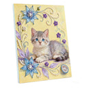 A square canvas art print featuring a fluffy gray kitten with blue eyes, surrounded by decorative blue flowers, purple blossoms, and pearl-like swirls on a pale yellow background.