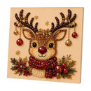 A square diamond painting or bead art piece featuring a festive reindeer with large antlers, a red nose, a red and cream beaded scarf, and holiday decorations including red ornaments, gold stars, and green pine branches on a beige background.