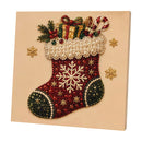 A square canvas wall art piece featuring a festive Christmas stocking embellished with red glitter, white pearl beadwork, gold snowflakes, green pinecones, candy canes, and wrapped gifts, displayed on a beige background.