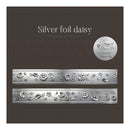 Silver foil daisy patterned paper strip set on a dark brown textured background, with two horizontal strips shown and a circular label reading 'Silver foil daisy'.