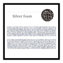 A product display card for 'Shimmering Snowflakes' washi tape. The card features a black border, the product name in black text, a circular logo for 'Agile Silver Color' in the top right, and two horizontal strips of the silver and white snowflake patterned tape in the center.