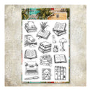 A sheet of clear stamp designs featuring black ink illustrations of books, an open book, a typewriter, a lamp, flowers, and stationery, displayed on a textured beige background with a decorative header card.