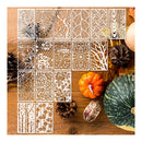 A set of 24 laser-cut wooden stencil panels featuring various autumn and forest patterns, arranged on a rustic wooden table with pumpkins and pinecones.