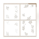 Four square white sheets arranged in a 2x2 grid on a light beige background, each printed with small decorative floral and leaf motifs in a warm taupe tone.