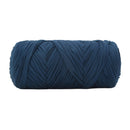 A single ball of thick, textured yarn in a deep navy blue color, photographed against a solid white background.