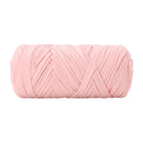 A single ball of light pink chunky yarn, photographed against a solid white background.