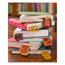 pile of books with handmade crochet book marks in the books