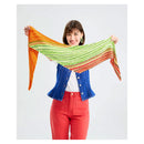 Woman holding a colorful striped shawl against a white background