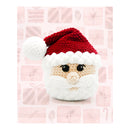 Crocheted Santa Claus amigurumi head and hat on a pink Christmas themed background