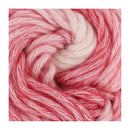 A close-up of variegated pink and white yarn wound into a spiral, showing the soft, fuzzy texture of the fibers.