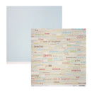 A sheet of scrapbooking paper with a colorful retro-themed word collage pattern on a cream background, shown next to a matching light blue rectangular card or backing on a plain white background.