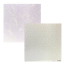 Two square sheets of patterned paper on a white background. The top-left sheet is pale lavender with a fine white floral outline pattern, and the bottom-right sheet is off-white with tiny scattered multicolor flecks and a subtle silver foiled grid texture at the bottom.