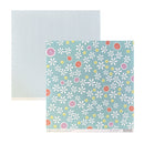 Two sheets of patterned scrapbook paper on a white background. The back sheet has thin vertical blue and white stripes, and the front sheet has a light blue background with a white daisy floral pattern and small pink, orange, and yellow dots.