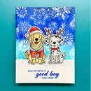 A square greeting card featuring two dogs at the Christmas tree: one golden dog in a Santa hat and coat, and one Dalmatian with reindeer antlers. The card has a blue watercolor snowflake background and reads 'YOU'VE BEEN A good boy THIS YEAR' on a white lower section.