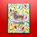 A rectangular greeting card with a festive holiday design, featuring a dachshund wearing a Santa hat and a sweater covered in colorful Christmas lights, with the text 'HAPPY Howliday' on a red background.