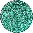 Close-up of teal glitter on a white background