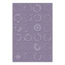 A rectangular silicone mold with embossed coffee ring patterns in a lavender-purple color, shown against a plain white background.