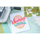Handmade card with 'Hooray' and 'Congratulations' text on a crafting table.