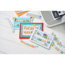 Colorful birthday cards with decorative elements on a white surface.