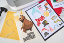 Birthday card with bear illustration and party hats on a printer bed