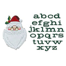A Christmas-themed alphabet embroidery or applique design on a white background, featuring a Santa face with a white beard, red hat, and green holly, alongside the lowercase alphabet letters 'abcd efghi jklmn opqrs tuvw xyz' in dark green.