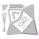 A set of gray metal cutting dies arranged on a white background, with some outlines highlighted in purple. The dies include decorative scrollwork, ribbon, envelope, and label shapes.