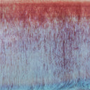 A close-up of a textured fabric or material swatch with a vertical ribbed pattern, showing a color gradient from a warm reddish-brown at the top to pale lavender and light blue at the bottom.