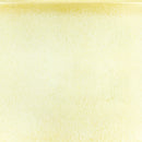 A close-up texture swatch of a pale, warm cream or buttery yellow material with subtle mottling and a slightly textured surface.