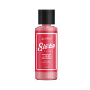 Red bottle of Speedball Studio Plus ink on a white background