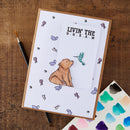 A handmade greeting card featuring a stamped white panel with the text 'LIVIN' THE D.R.