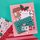 Christmas-themed stationery set with envelopes, postcard, and stamps on a teal background