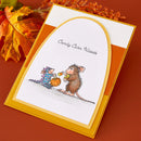 Greeting card with two mice holding candy corn on a brown background with autumn leaves.